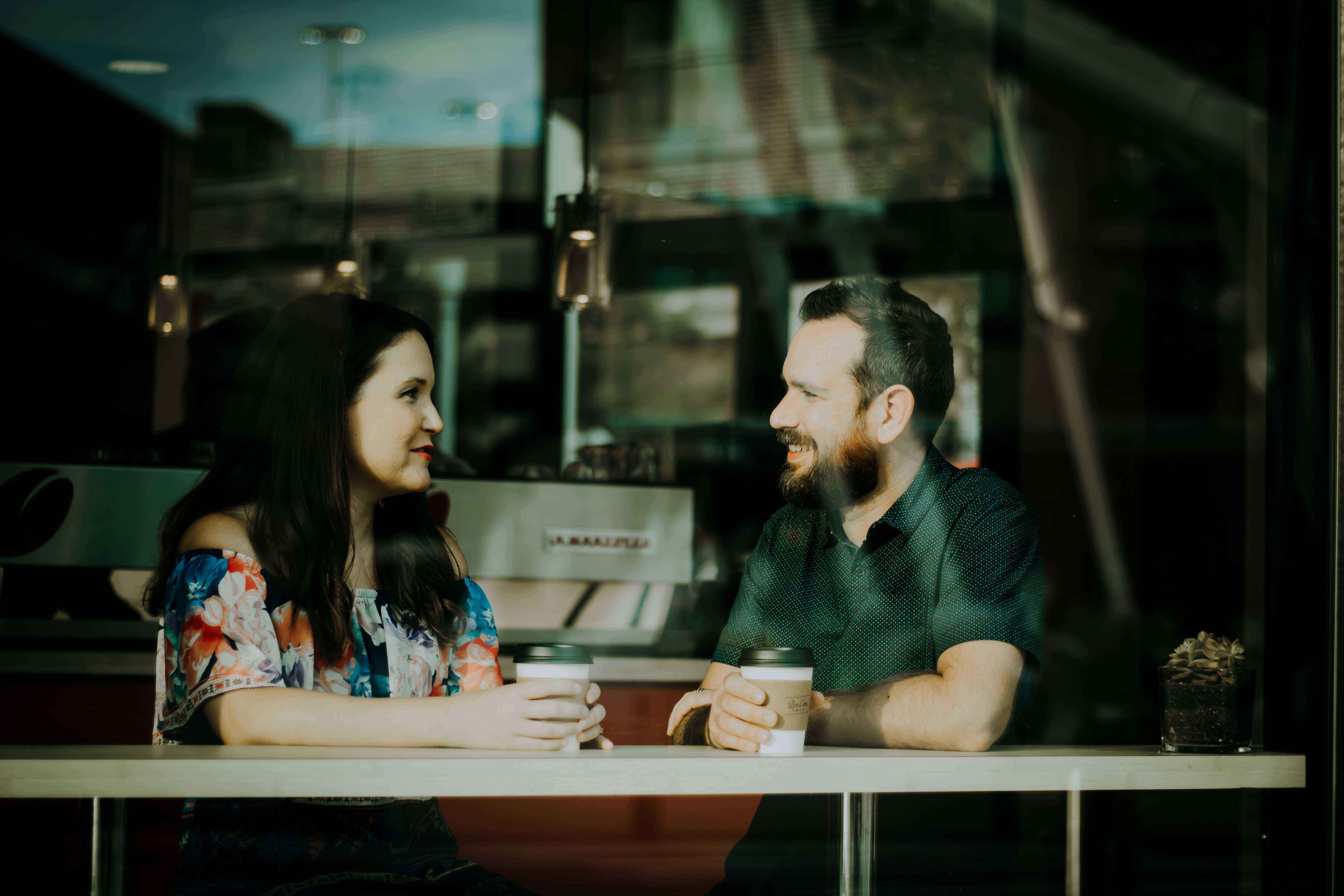 Two people talking at a cafe