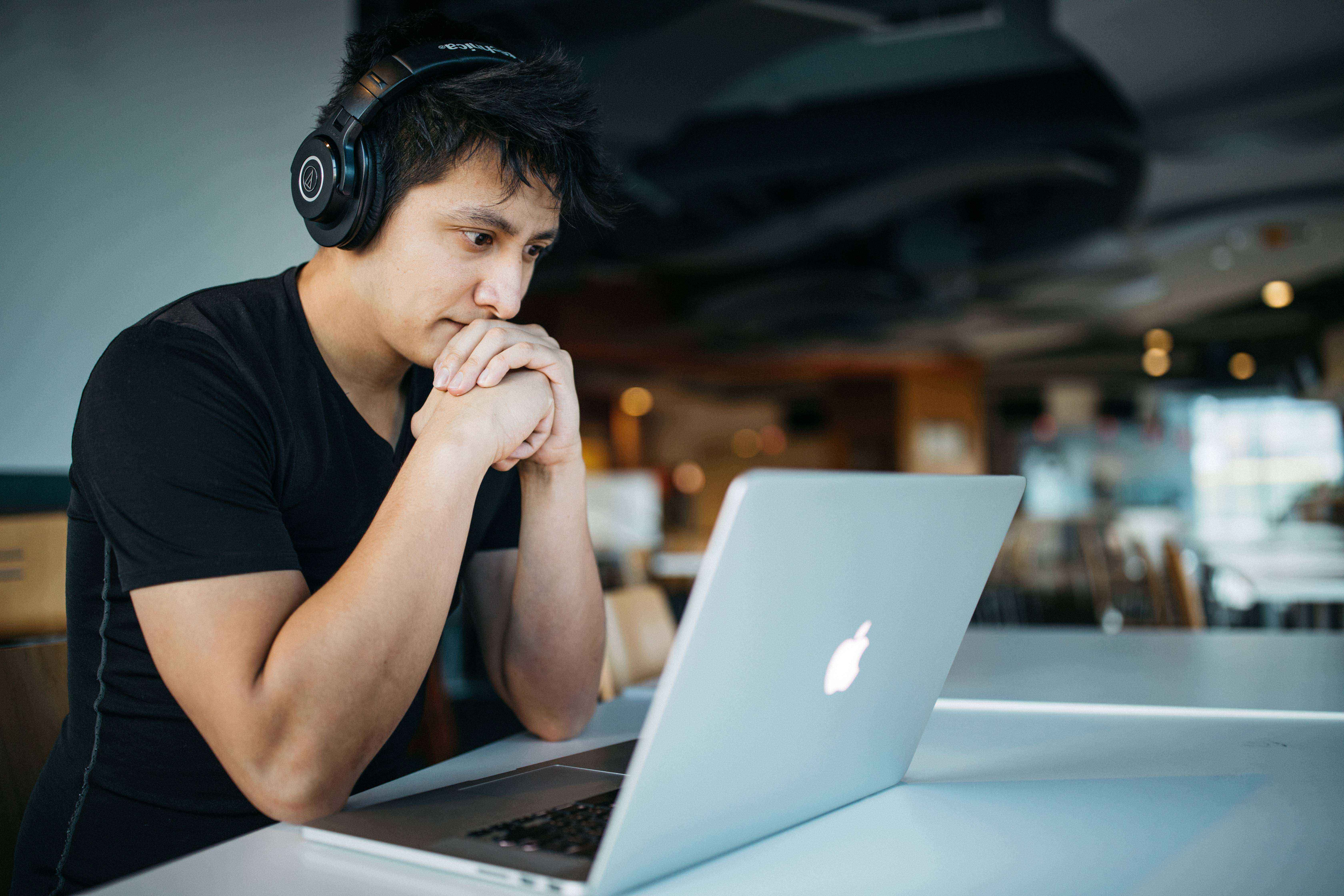 Man at computer looking at something difficult