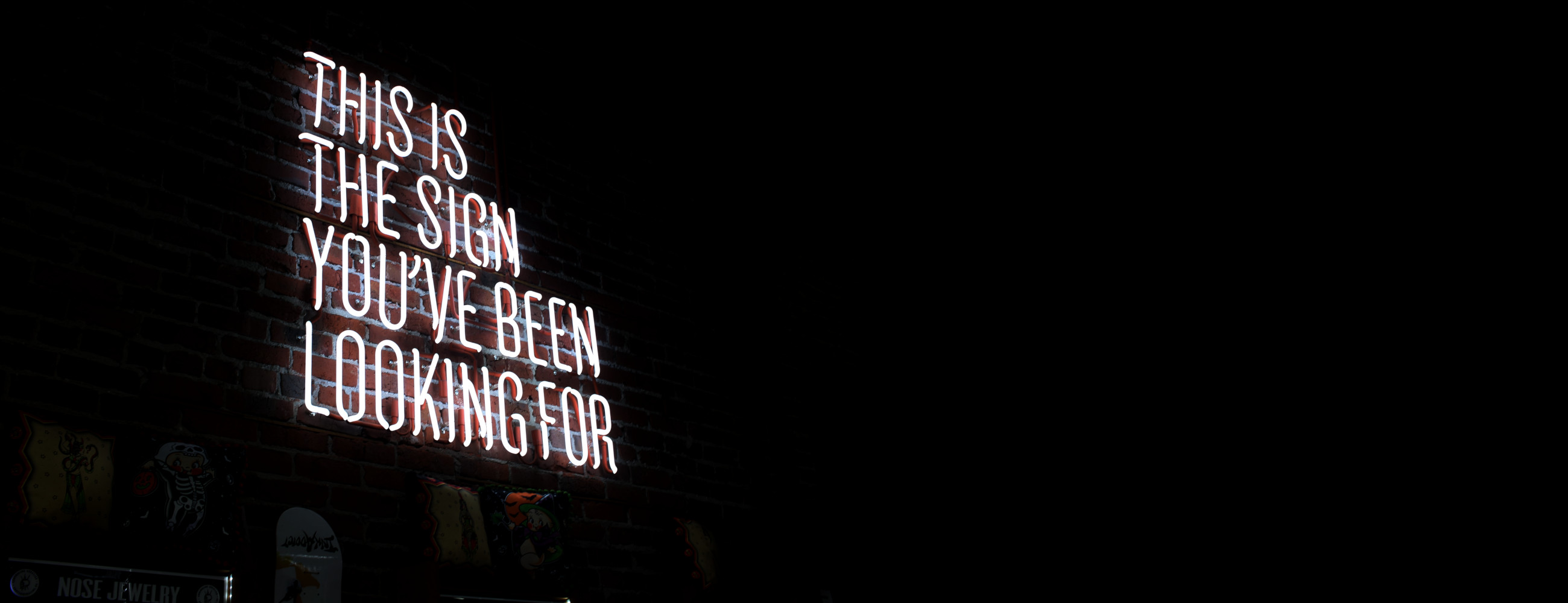 A neon sign saying "This is the sign you've been waiting for"